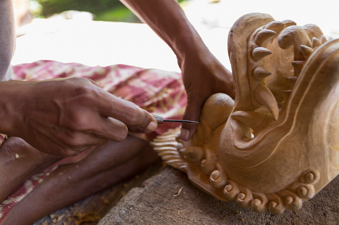 Wood worker chiseling piece in studio, Mas, Bali, Indonesia