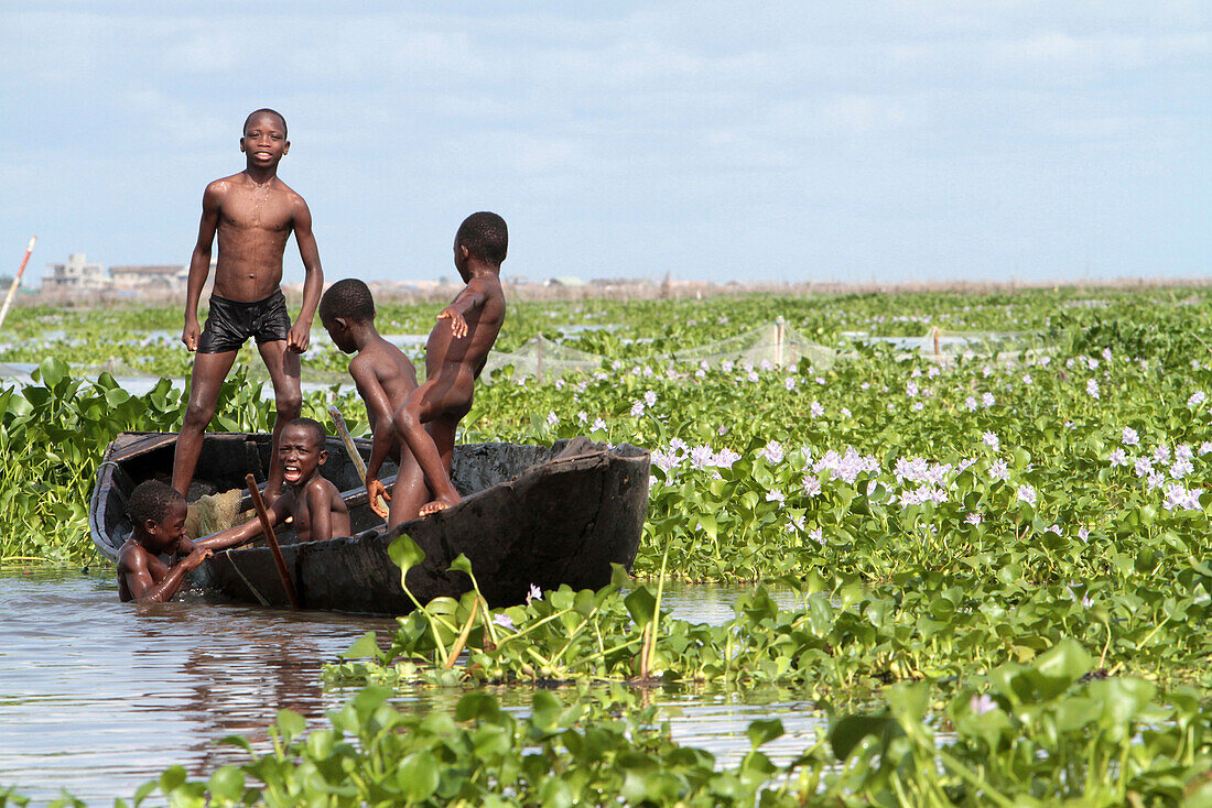 African children playing on a canoe. Lake Nokoue. Ganvie. Benin.