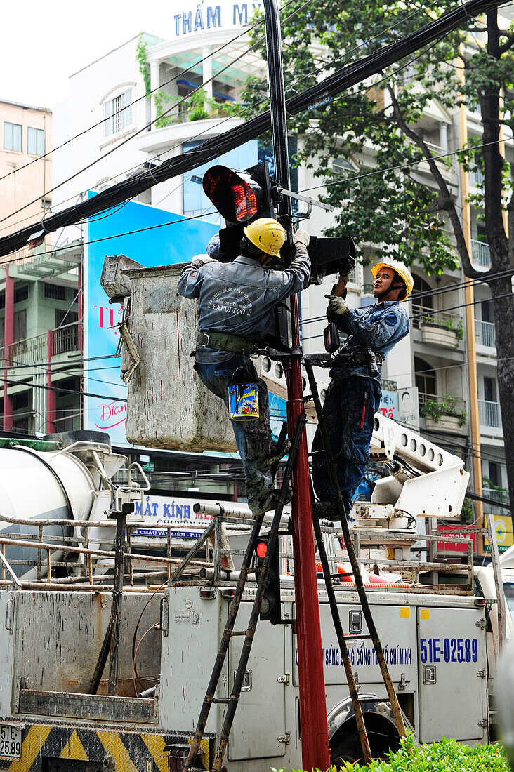 Electrician men at work in Ho Chi Minh City, Vietnam, South East Asia, Asia