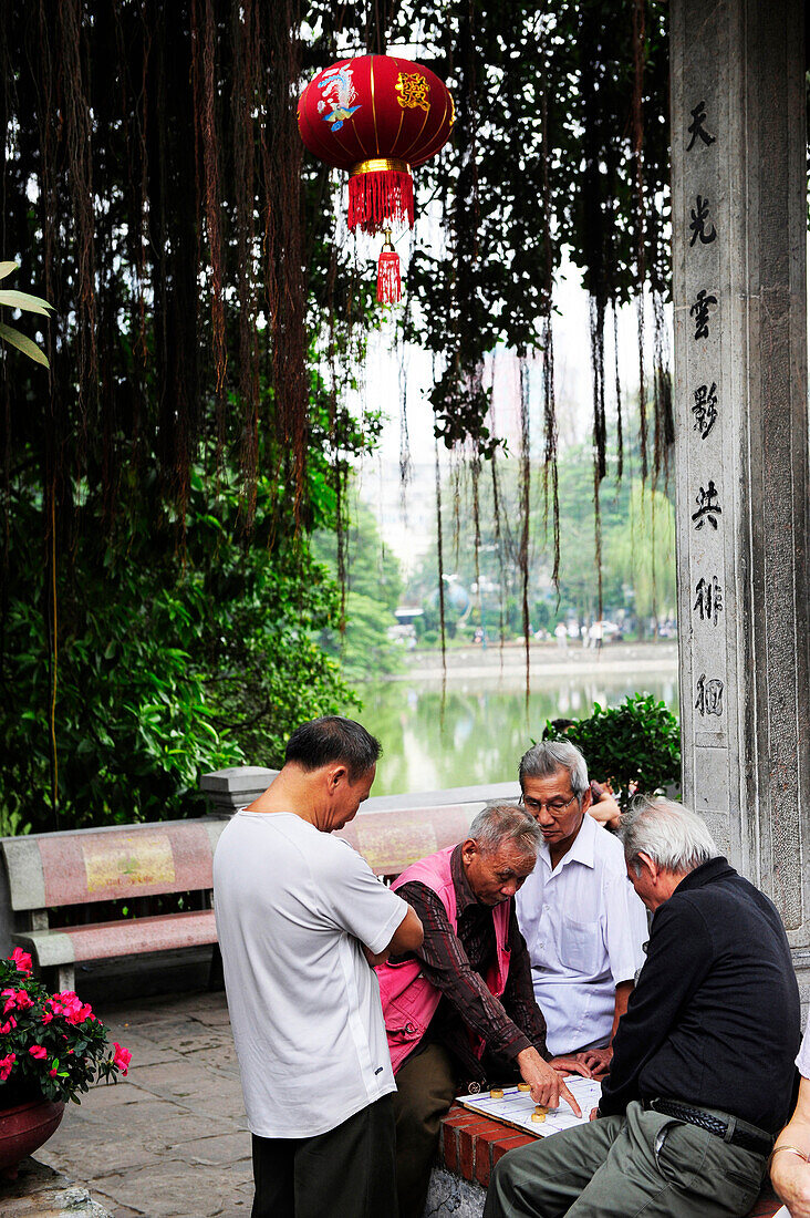A group of men playing chinese traditional chess game near Hoan Kiem lake in Hanoi, North Vietnam, Vietnam, South East Asia, Asia