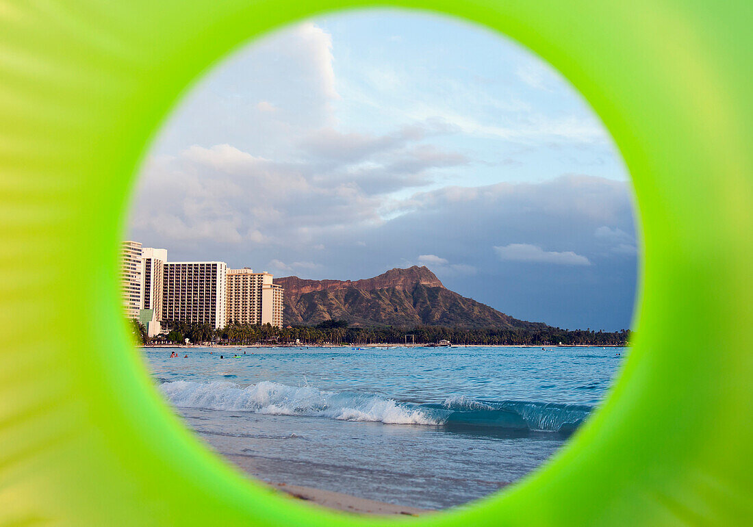 'View of Diamond Head seen through a green inflatable tube; Waikiki, Oahu, Hawaii, United States of America'