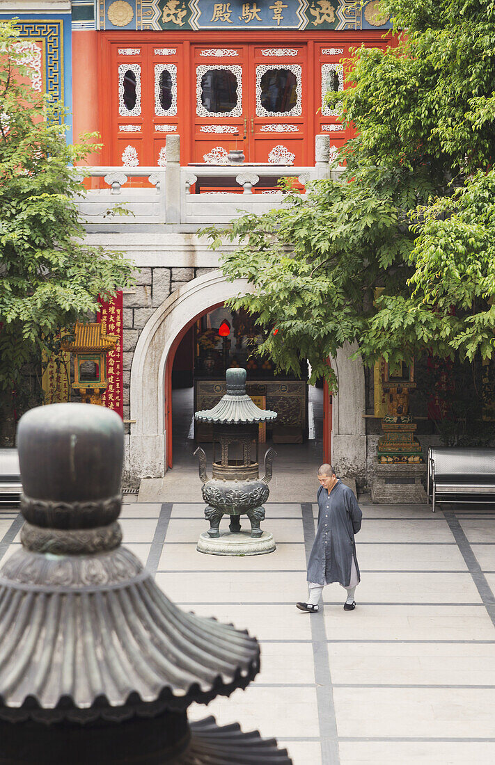 'A Priest Walking Across The Monastery Courtyard, Po Lin Monastery, Lantou Island; Hong Kong, China'