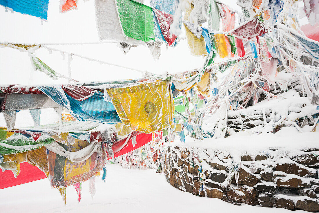 'Five-Color Prayer Flags With Mantras At The Snowed In High Mountain Pass, Tibet Stupa; Tibet, Sichuan, China'