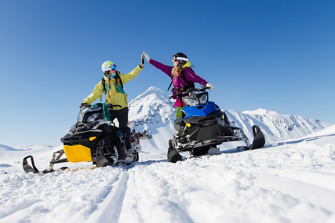 Lynsey Dyer And Sierra Quitiquit On Their Snowmobiles Ready For Some Backcountry Skiing In The Chugach Mountains, Late Winter Southcentral Alaska.