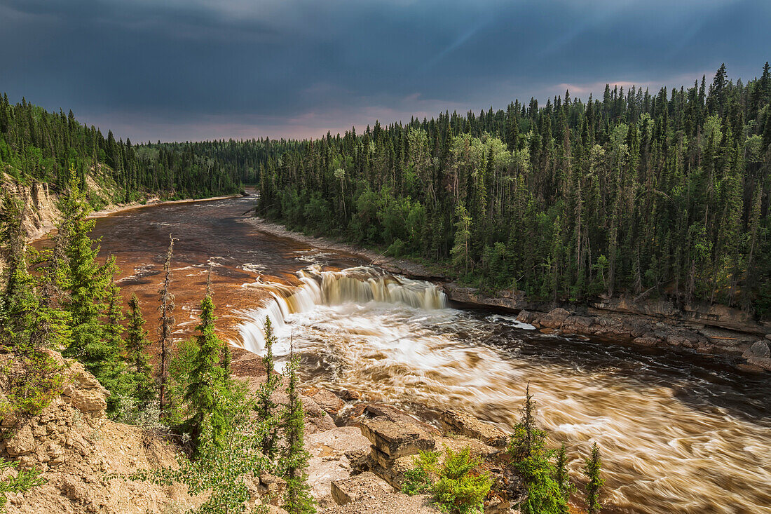'Sunlight Illuminates The Trout River Flows Over Coral Falls; Northwest Territories, Canada'
