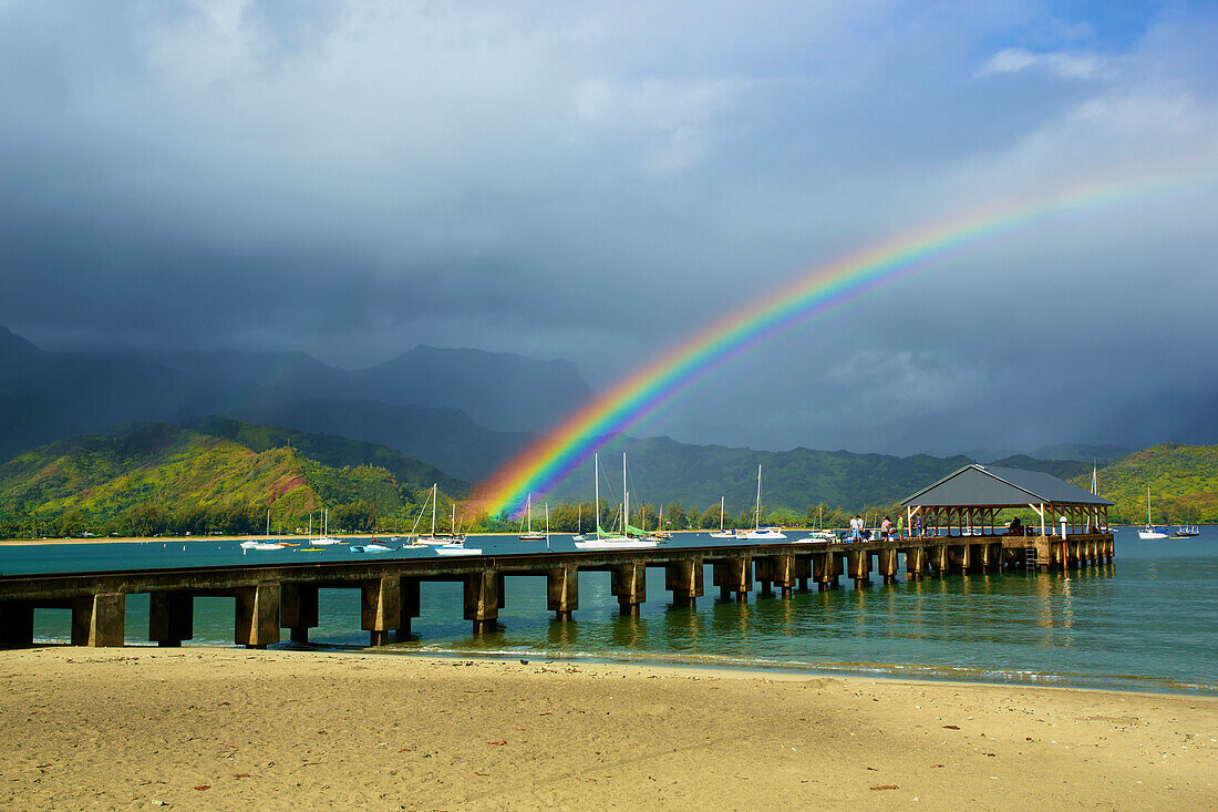 'A rainbow over Hanalei pier in Hanalei bay; Kauai, Hawaii, United States of America'