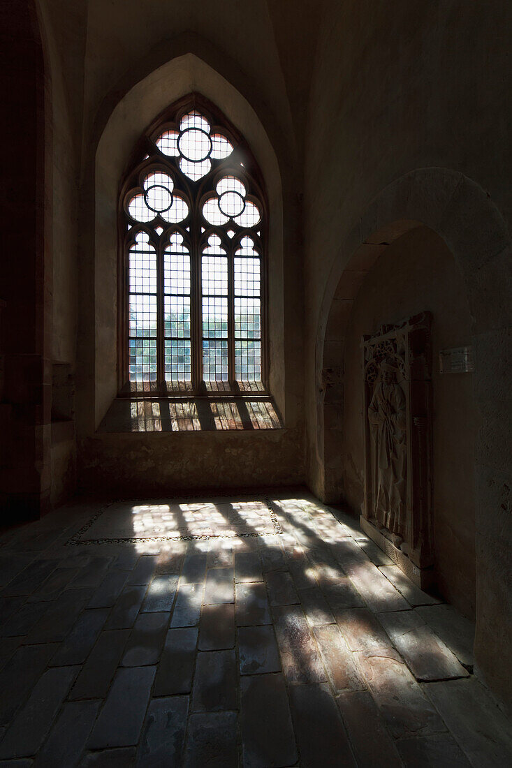 Wall grave slab and window of the basilica of Eberbach Abbey, Germany