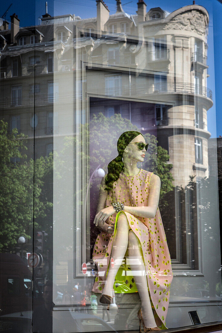 Reflection of a mannequin in the window of the dior boutique, rue francois 1er, 8th arrondissement, paris, france