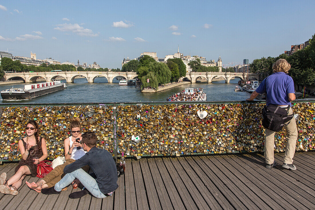 A stroll on the quays of the seine, pont des arts bridge covered in love padlocks, quay of the louvre, paris (75), france