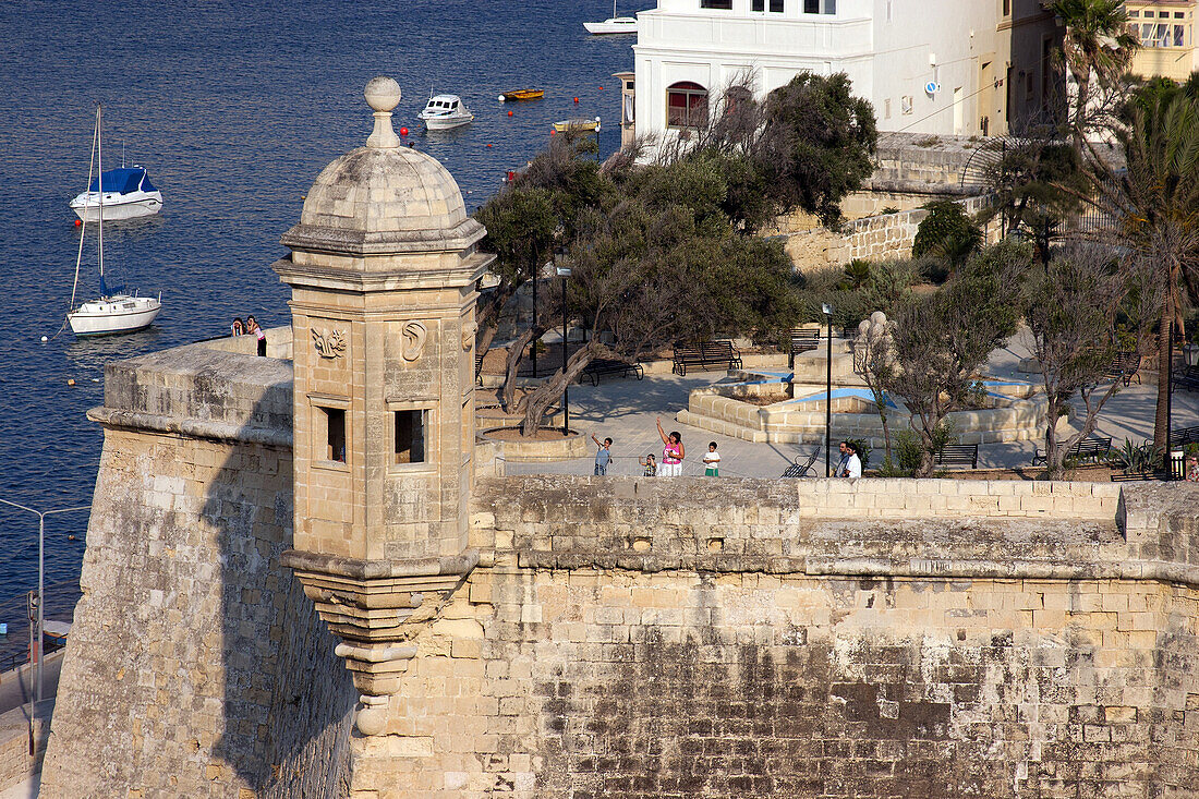 People of malta waving to the passengers on a cruise ship from the ramparts of the saint-michael fort, senglea, big port of la valette, malta