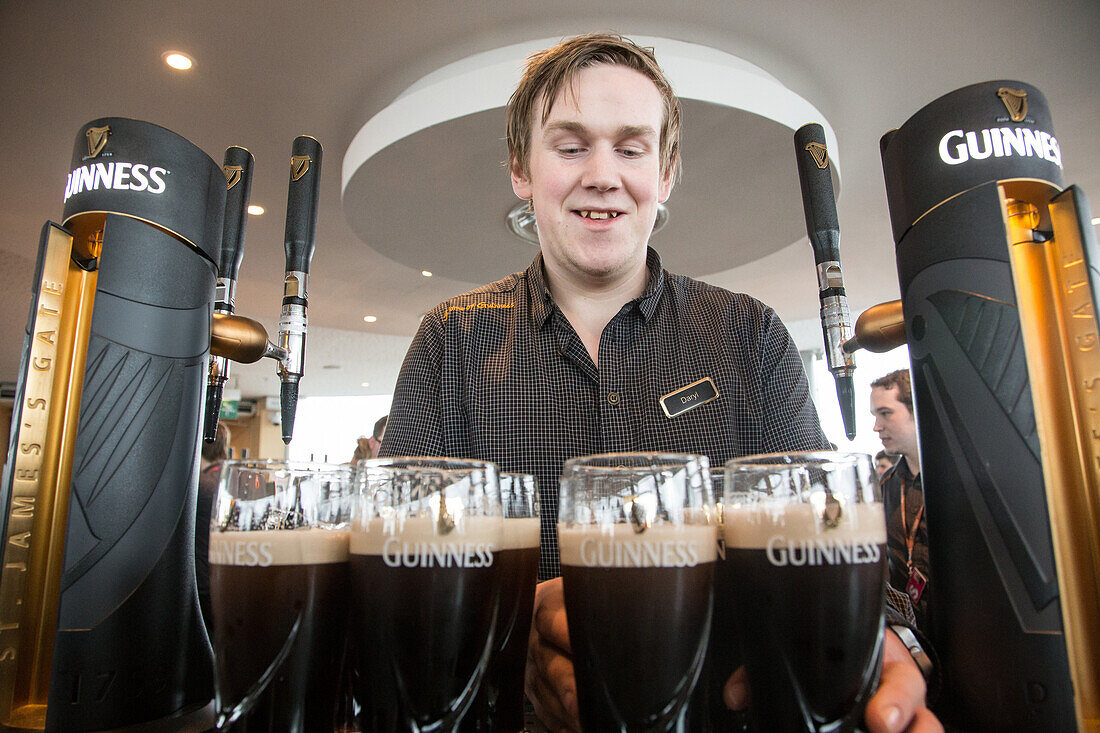Serving dark draught ale at the old brewery, guinness storehouse, dublin, ireland