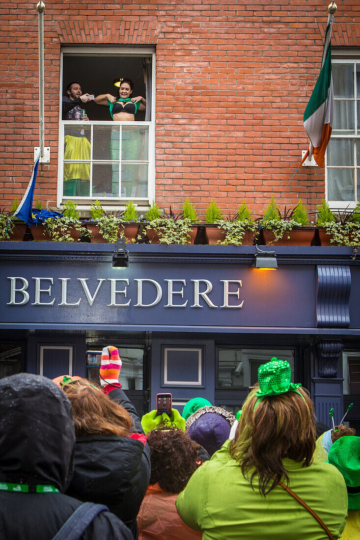 Spectators on balconies and at windows for the saint patrick's day festivities, dublin, ireland