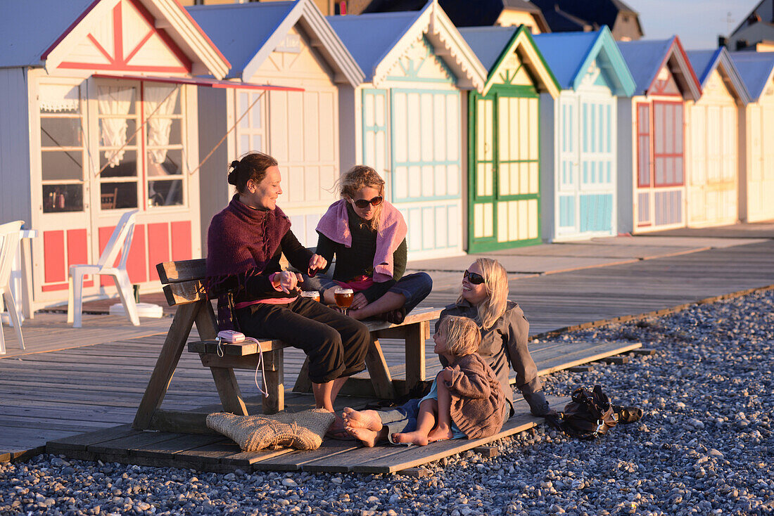 Group of friends in front of the beach huts, bay of somme, somme, picardy, france
