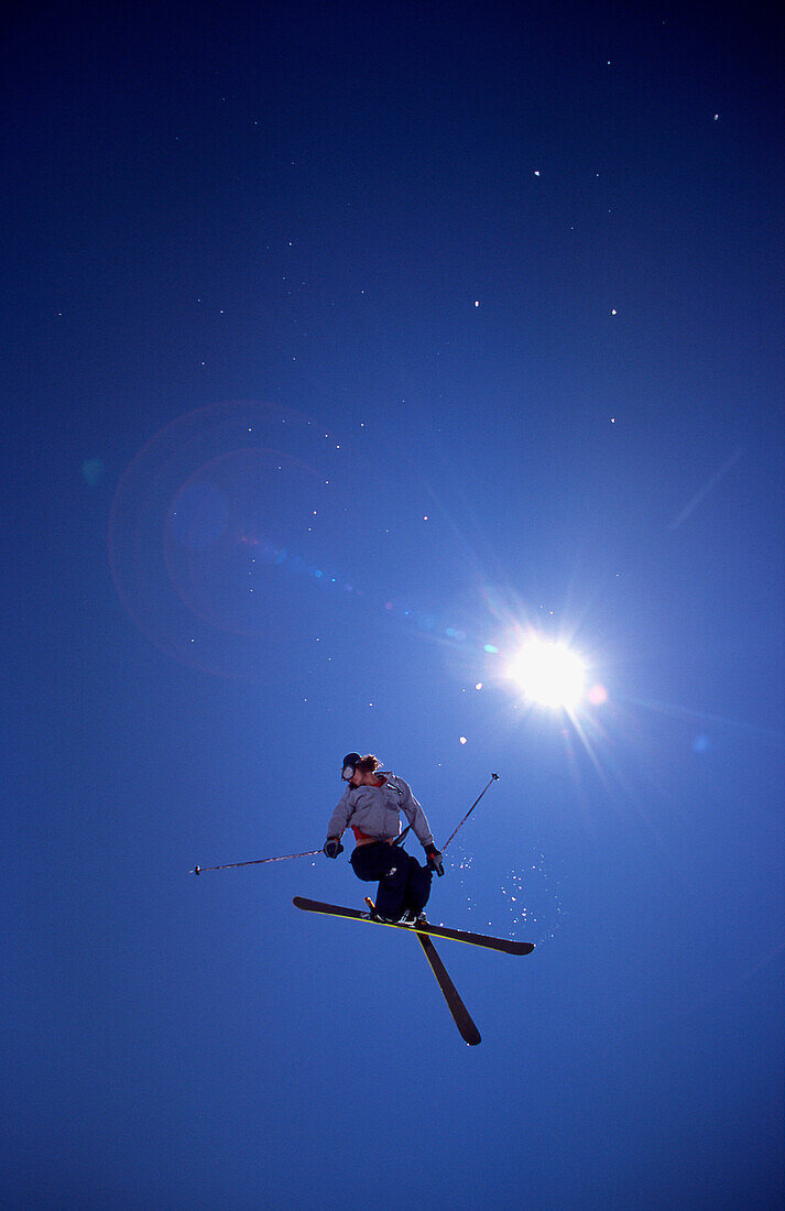 Skier in Sky with Sun Flare