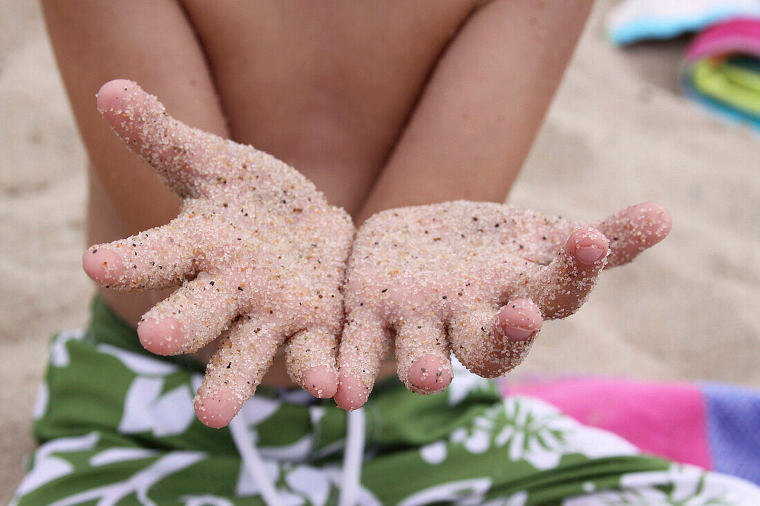 Boy's Hand Covered in Sand