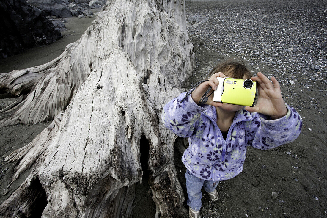 Young Girl Taking Picture on Beach, Redwood National Park, California, USA