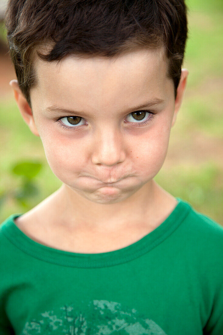 Young Boy Making Funny Face With Cheeks and Mouth