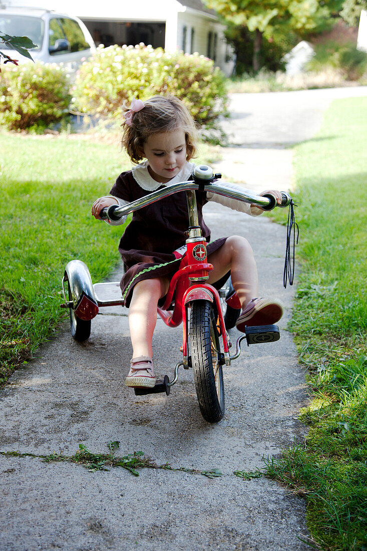 Young Girl Riding Tricycle