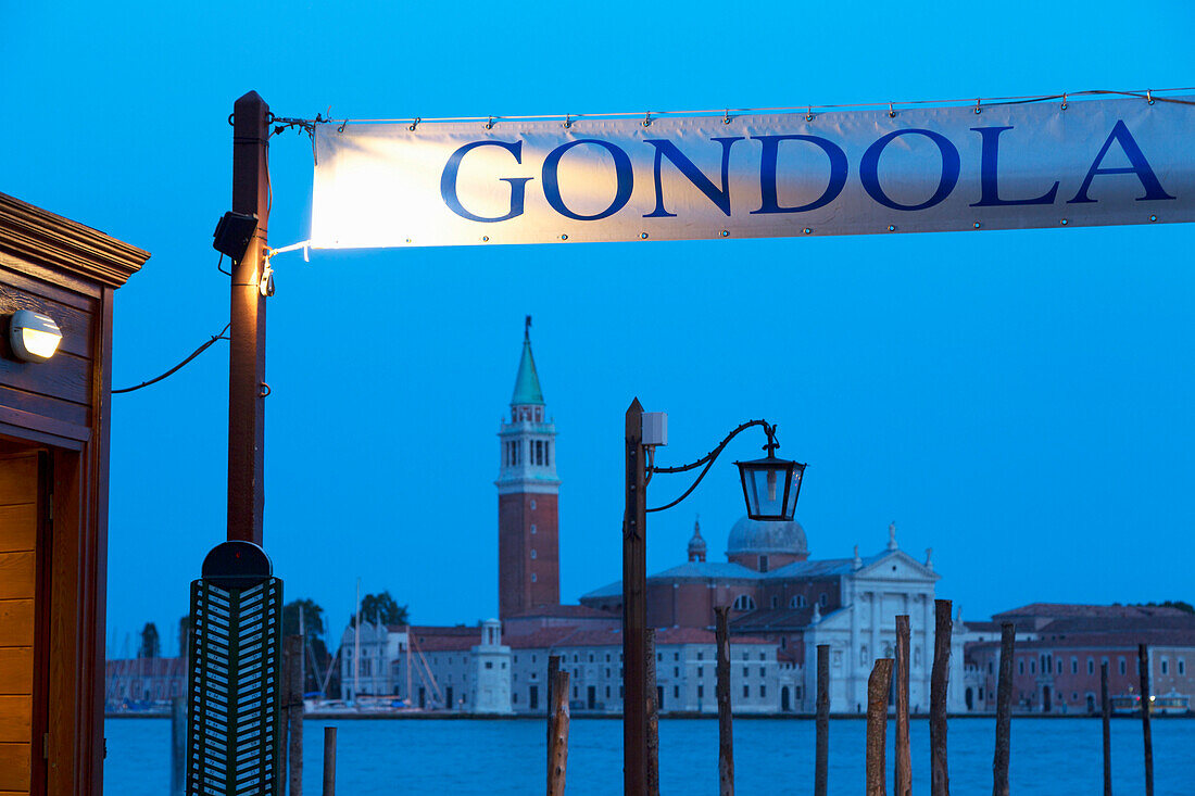 Gondola station near St. Mark's Square at night, with San Giorgio Maggiore in the distance, Venice, UNESCO World Heritage Site, Veneto, Italy, Europe