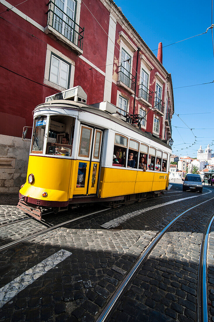 Famous tram 28 going through the old quarter of Alfama, Lisbon, Portugal, Europe