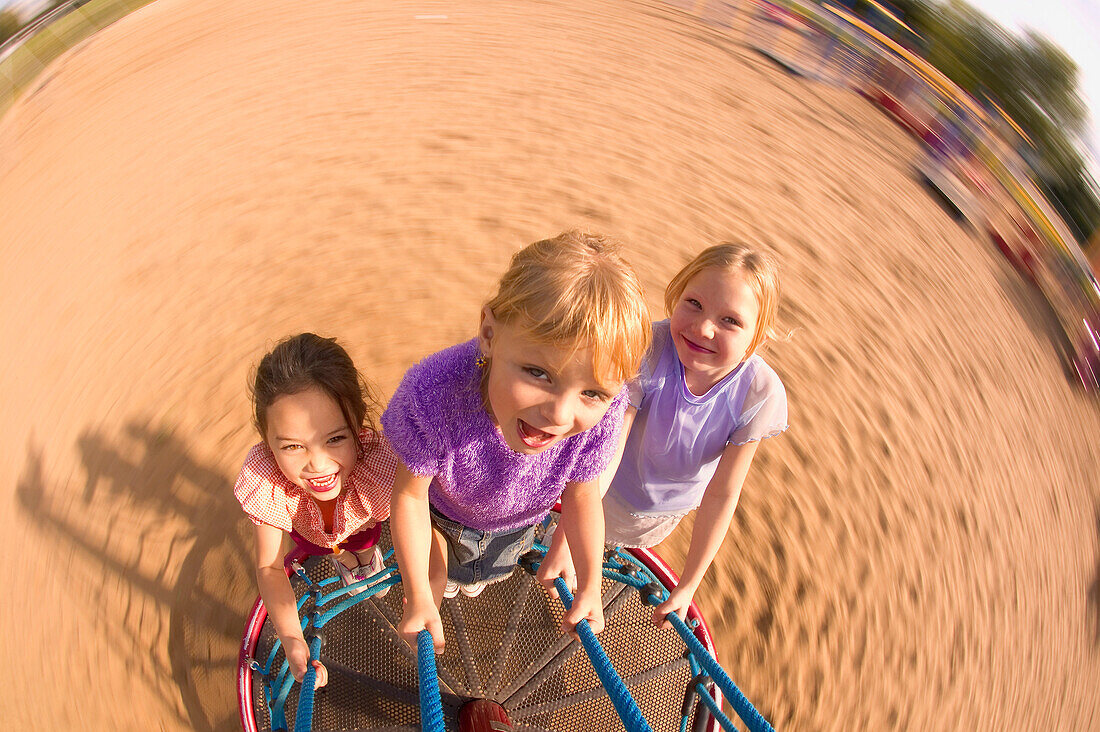 Children Spinning On Playground