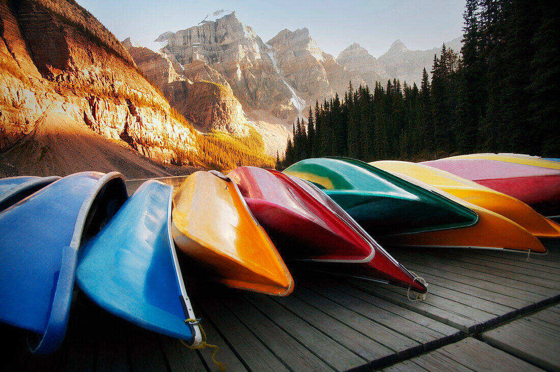 Multi-Colored Canoes Resting On A Dock