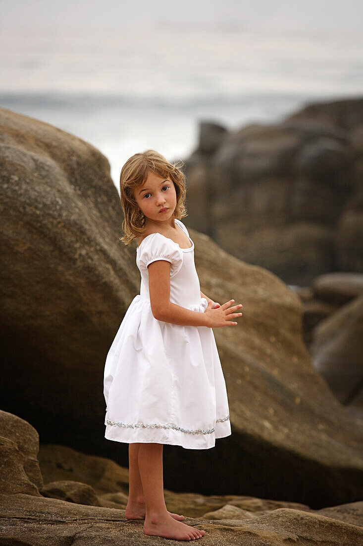 Girl Standing On The Rocks