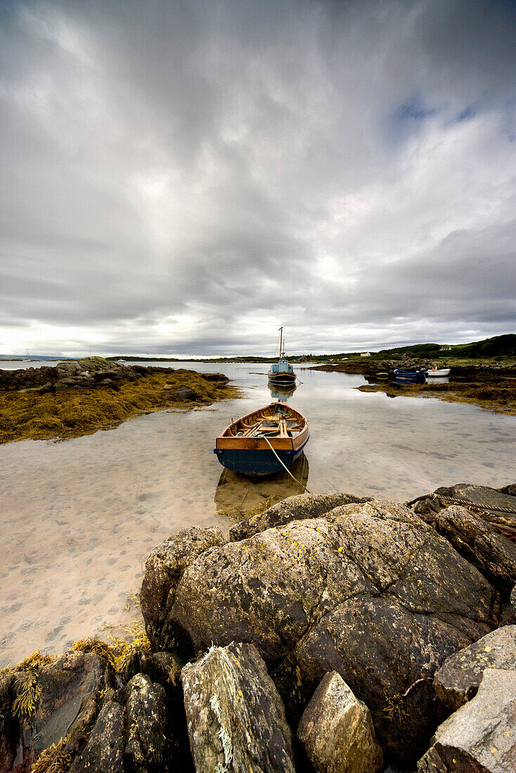 Boat Tied To Rocks On Shore