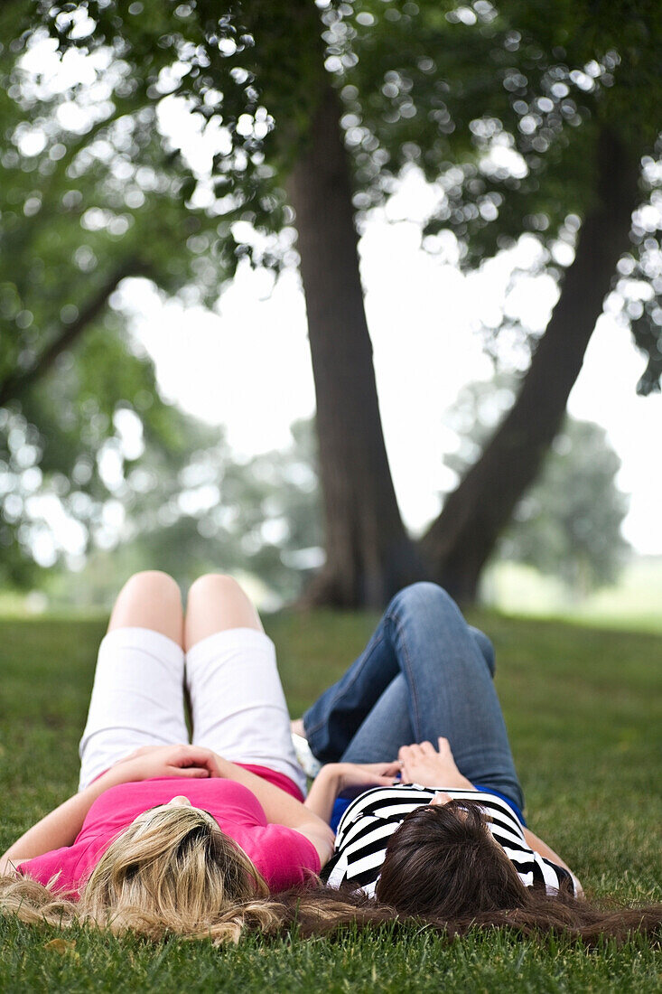 Two Girls Laying On The Grass