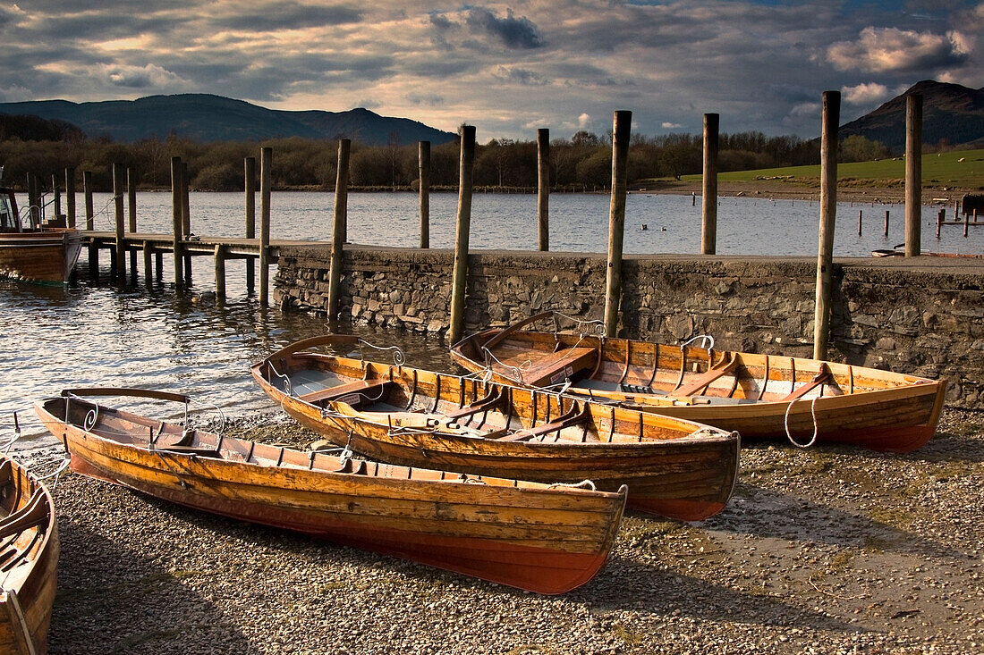 'Lake District, Cumbria, England; Four Rowboats On Shore'