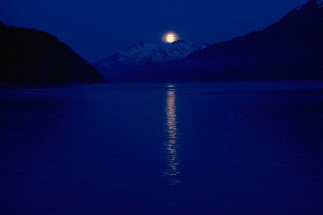 'Taiya Inlet, Skagway, Alaska, United States Of America; A Moon Over The Chilkat Mountains In The Lynn Canal Of The Inside Passage'