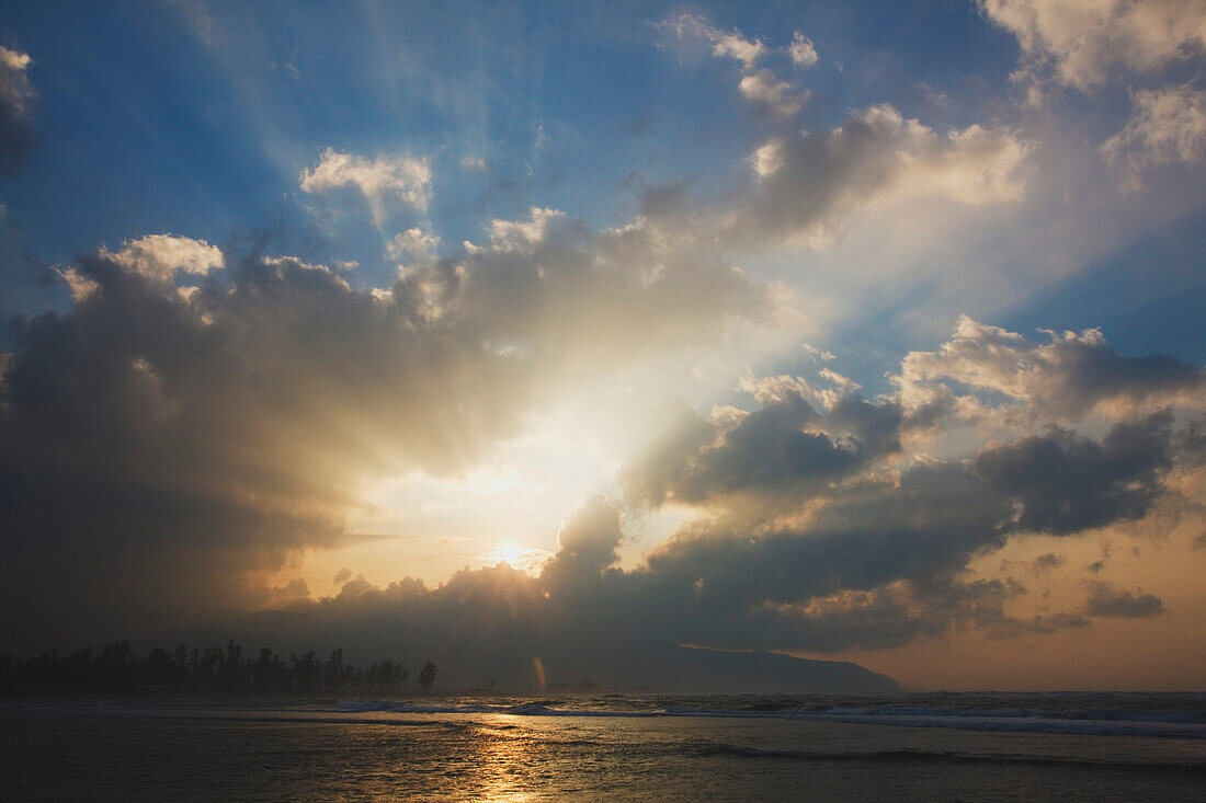 Sunburst Through The Clouds Over The Ocean