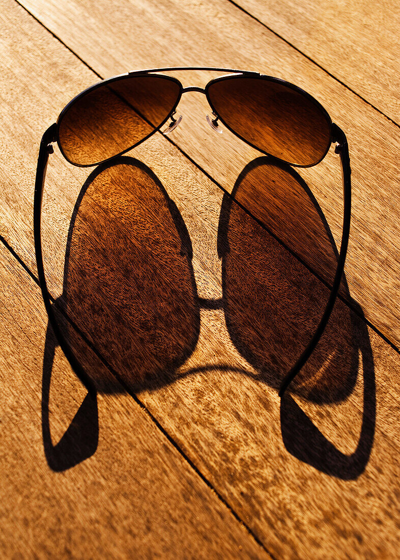 'Cadiz, Spain; Sunglasses Casting Their Shadow On A Wooden Boardwalk'