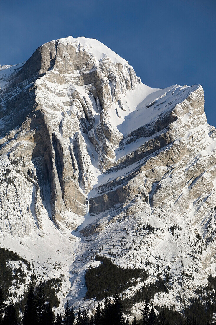 'Alberta, Canada; Snow Covered Mountain With Dramatic Fault Lines In Kananaskis Country'