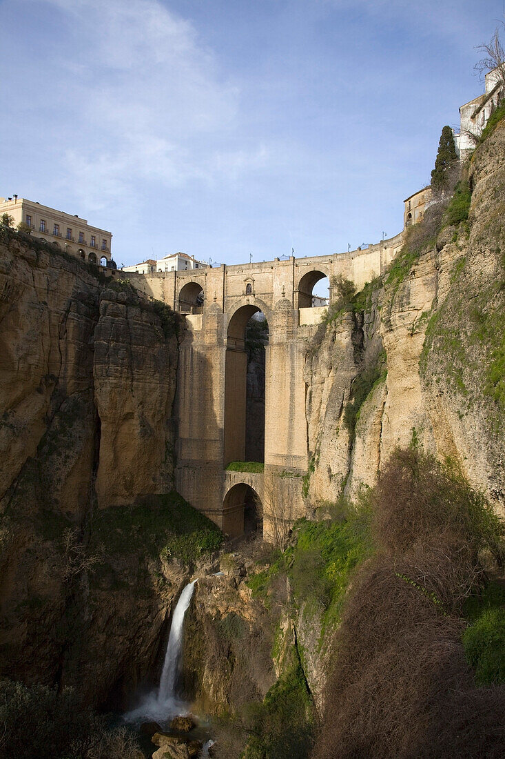 'Ronda, Andalusia, Spain; The Bridge With A Waterfall And Rock Cliffs'