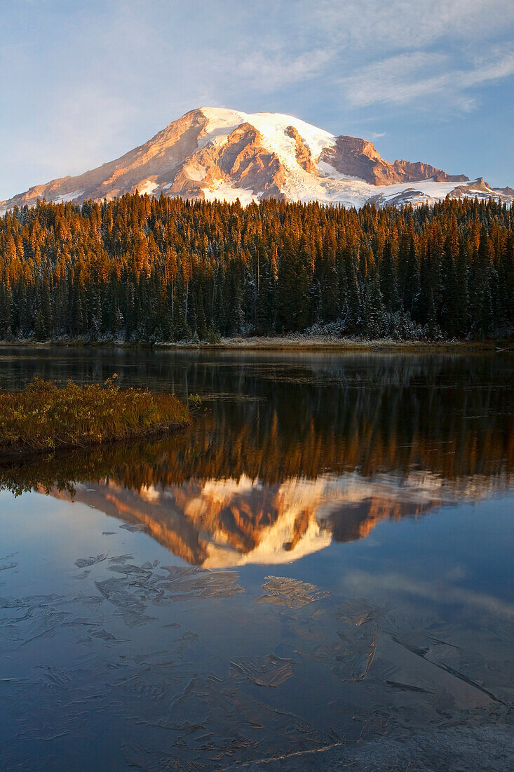 'Washington, United States Of America; Reflection Of Mount Rainier In A Lake With Ice On The Surface In Mt. Rainier National Park'
