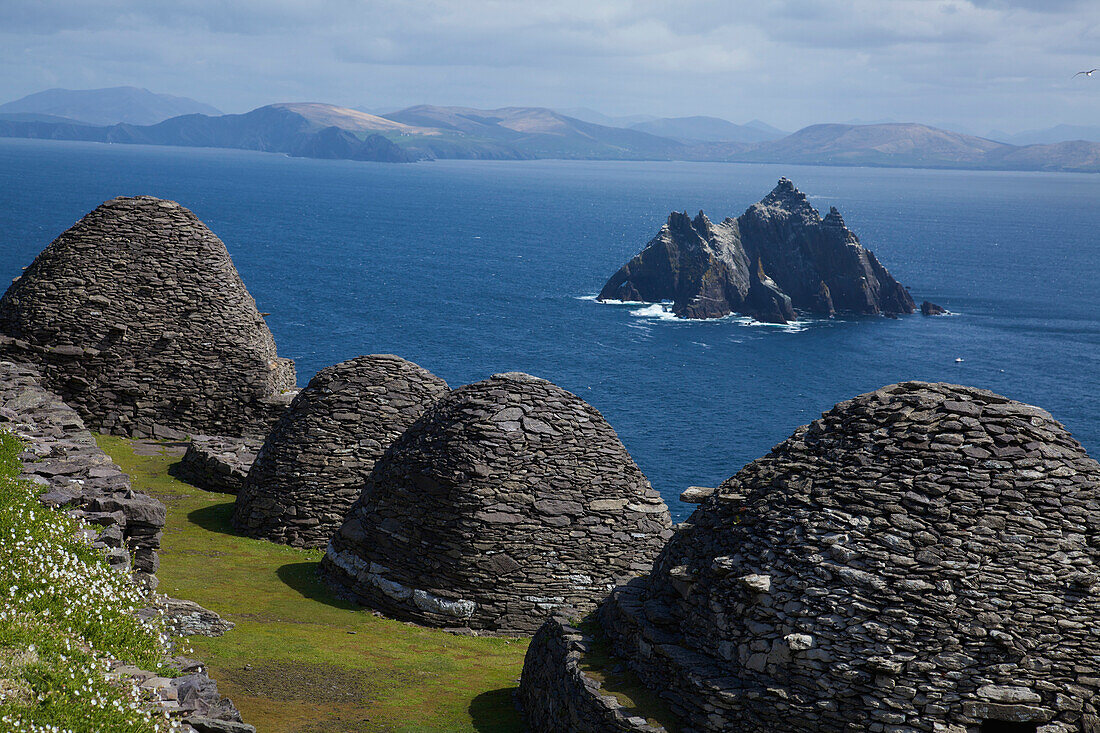'Skellig Michael, County Kerry, Ireland; Stone 'beehive' Monk Huts (Clochans) With A View Of Skellig Beag'