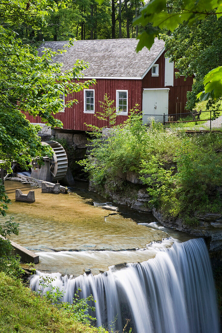 'Red Barn With A Mill Wheel And Waterfall; Thorold, Ontario, Canada'