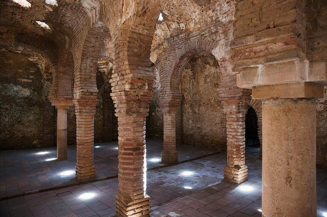 'Star Shaped Holes In The Ceiling Illuminate The Arab Bath's Arches And Supporting Columns; Ronda, Andalusia, Spain'
