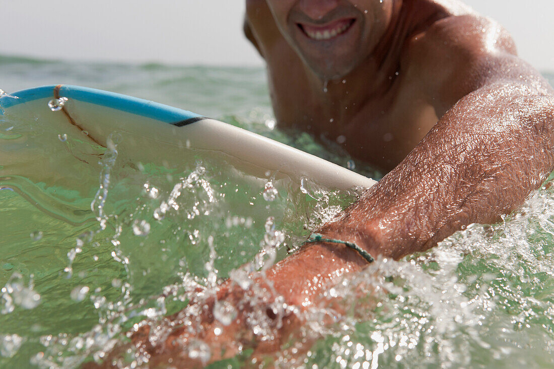 'A Man Paddling On His Surfboard Off Valdevequeros Beach; Tarifa, Cadiz, Andalusia, Spain'