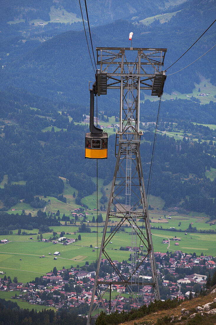 'Mountain Gondola And Tower With A Village In The Background; Oberstdorf, Germany'