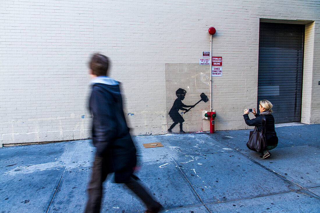 'USA, New York City. Street artist Banksy wall painting, October 20th 2013, on 79th Street, Broadway (Upper West Side), ''Better out than in'' an artists residency on the streets of New York'