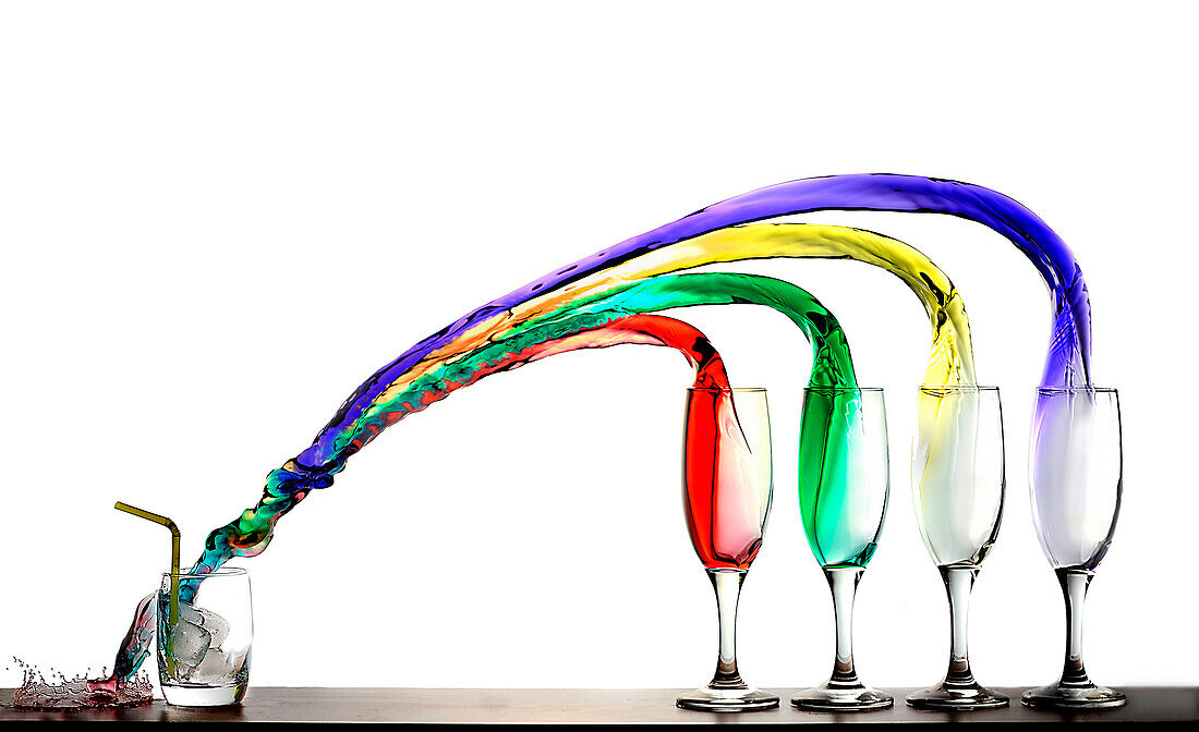 four glasses pour their colored liquid in a fifth glass.