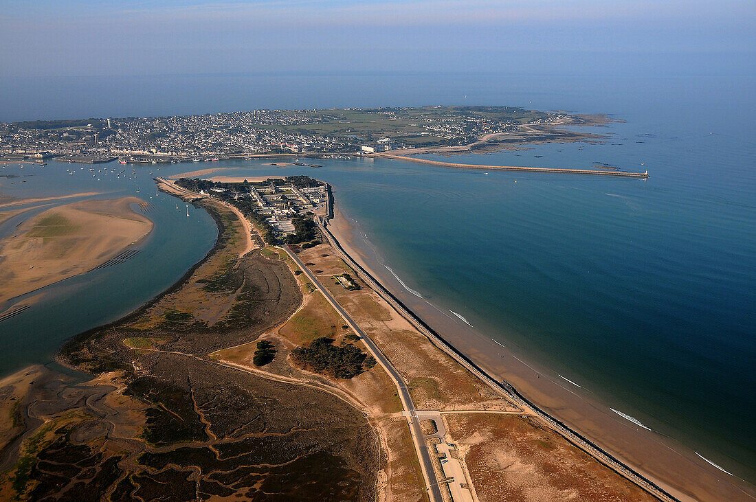 Aerial view of the port. Foreground, vertical photo, beach, road, buildings. Right left the sea sand. In the background, the harbor and pier to the right