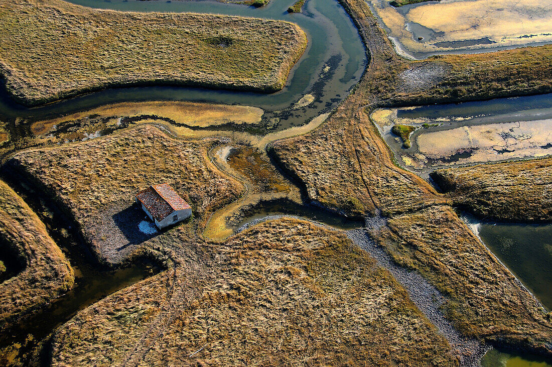 France. Marennes. Aerial view of Marsh Marennes. Channels and a house on the prairie.