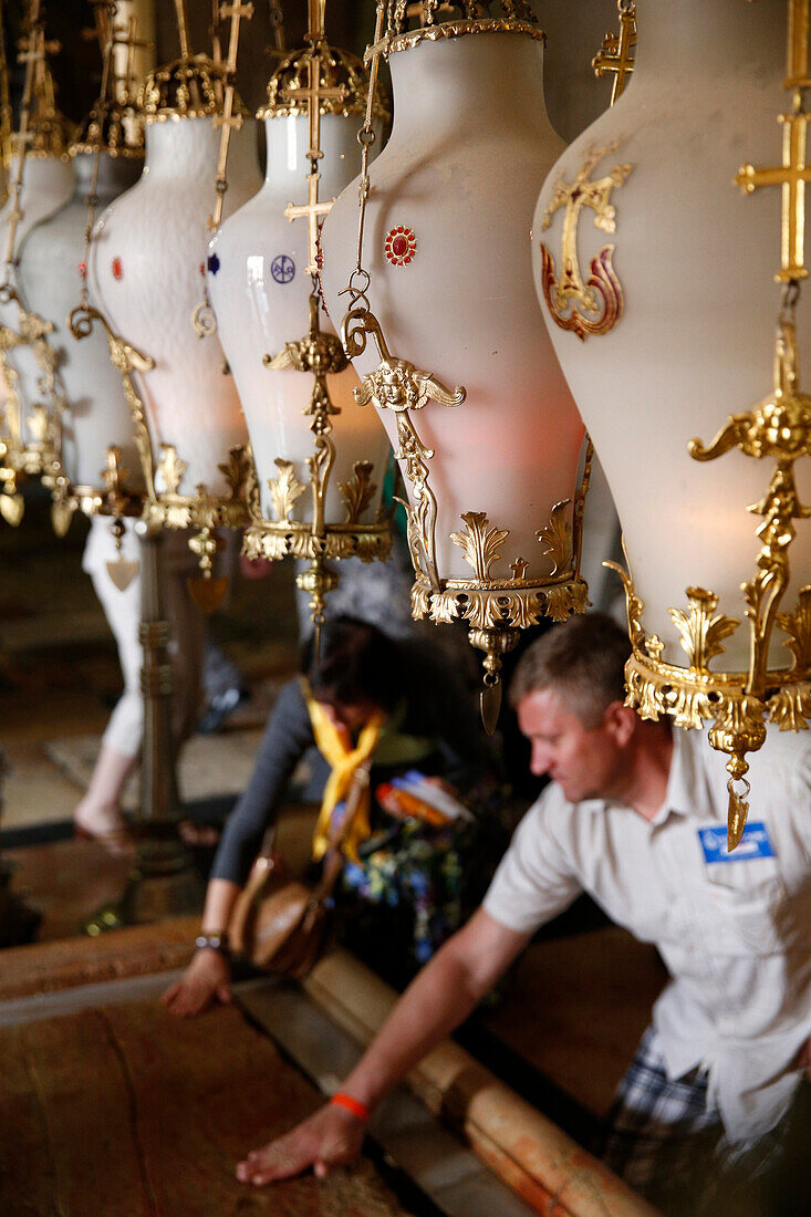 Traditional lamps hanging above the Stone of Anointing. Holy Sepulchre Church. Jerusalem. Israel.