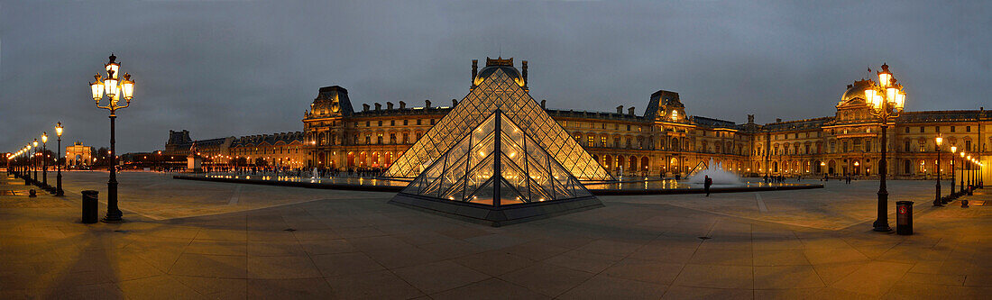France. panoramic night view of the Louvre in Paris and its pyramids