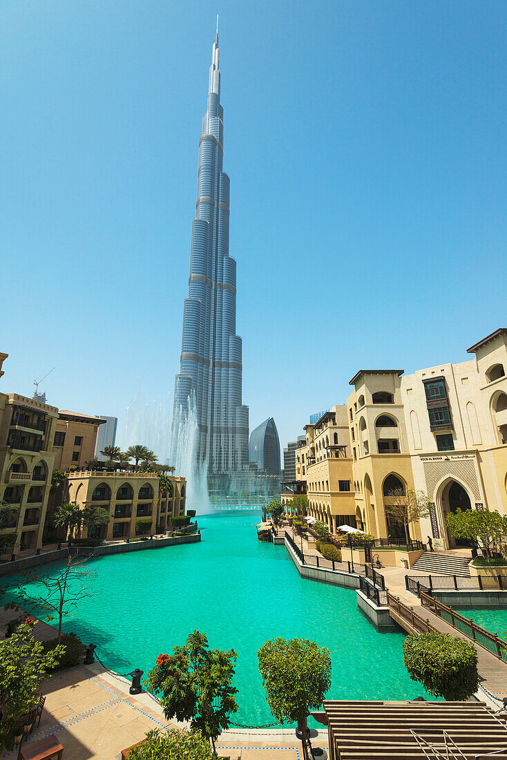 'Looking across large artificial lake to fountain display beneath the Burj Khalifa; Dubai, United Arab Emirates'