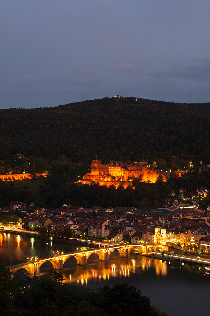 'Heidelberg Castle and the old bridge over River Neckar illuminated at nighttime; Heidelberg, Germany'