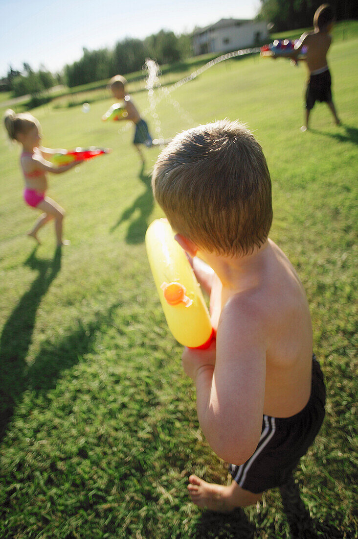Children Playing With Water Pistols